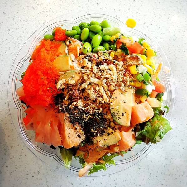 Sunfish Poke Bar's colorful poke bowl with salmon, avocado, edamame, corn, and bright orange roe.