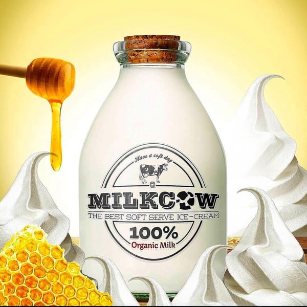 Milkcow soft serve ice cream bottle with honey dipper, honeycomb, and soft serve swirls.
